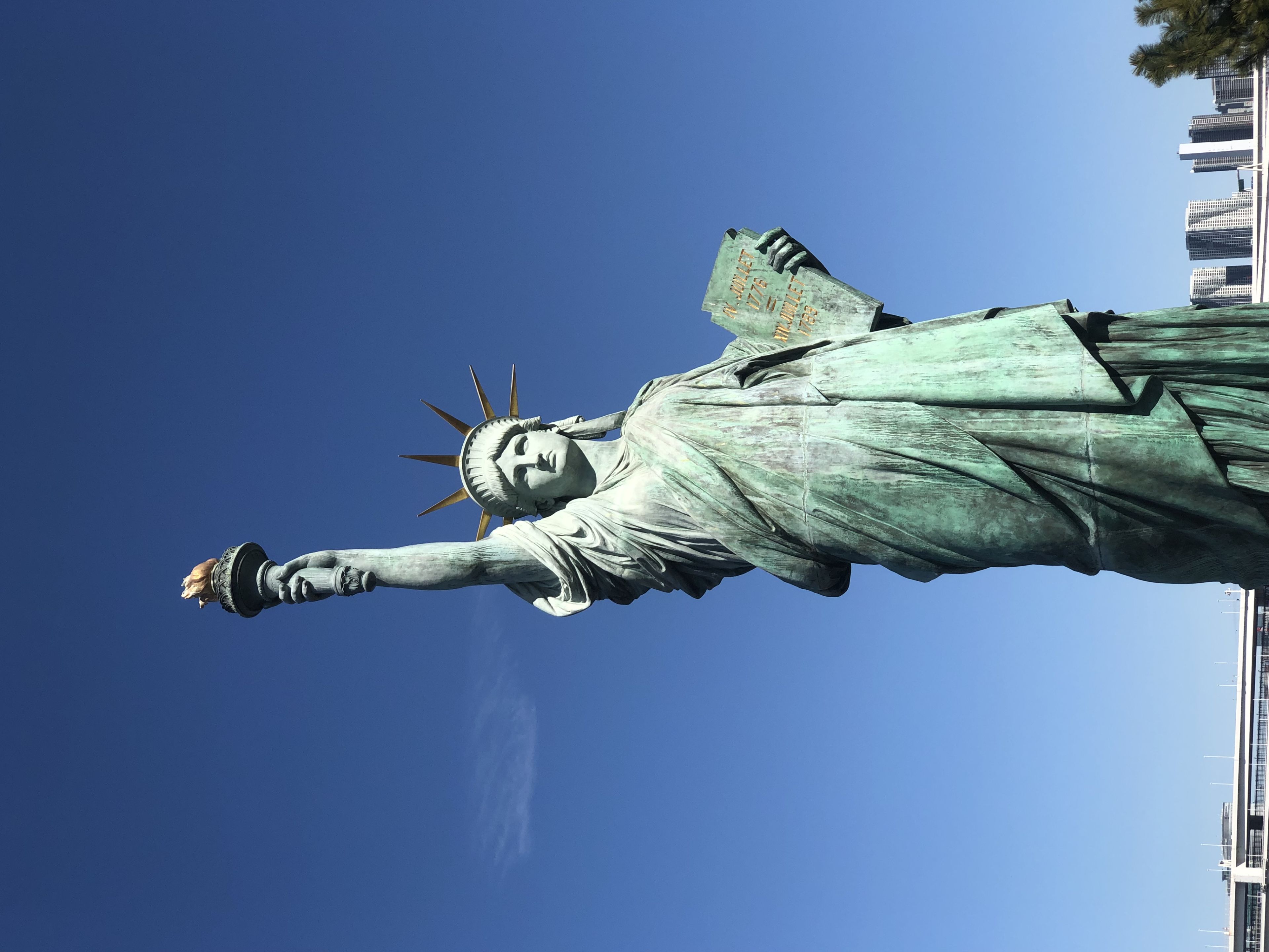 The Statue of Liberty against a clear blue sky